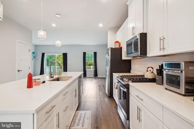 1724 Atlas Dr, Frederick, MD 21702 - kitchen with stainless steel appliances, a sink, white cabinetry, dark wood finished floors, and a kitchen island with sink