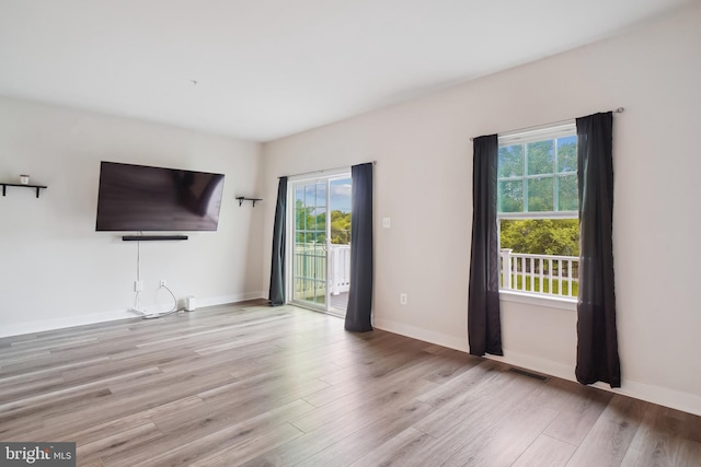 1724 Atlas Dr, Frederick, MD 21702 - unfurnished living room with healthy amount of natural light, wood finished floors, and baseboards