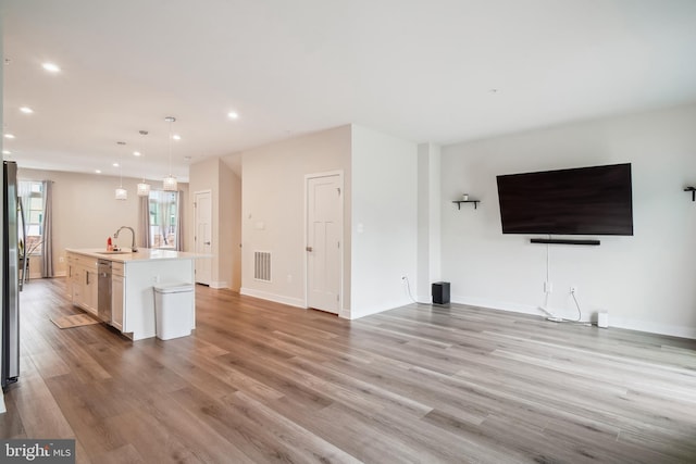 1724 Atlas Dr, Frederick, MD 21702 - kitchen with a sink, open floor plan, light countertops, light wood-style flooring, and recessed lighting