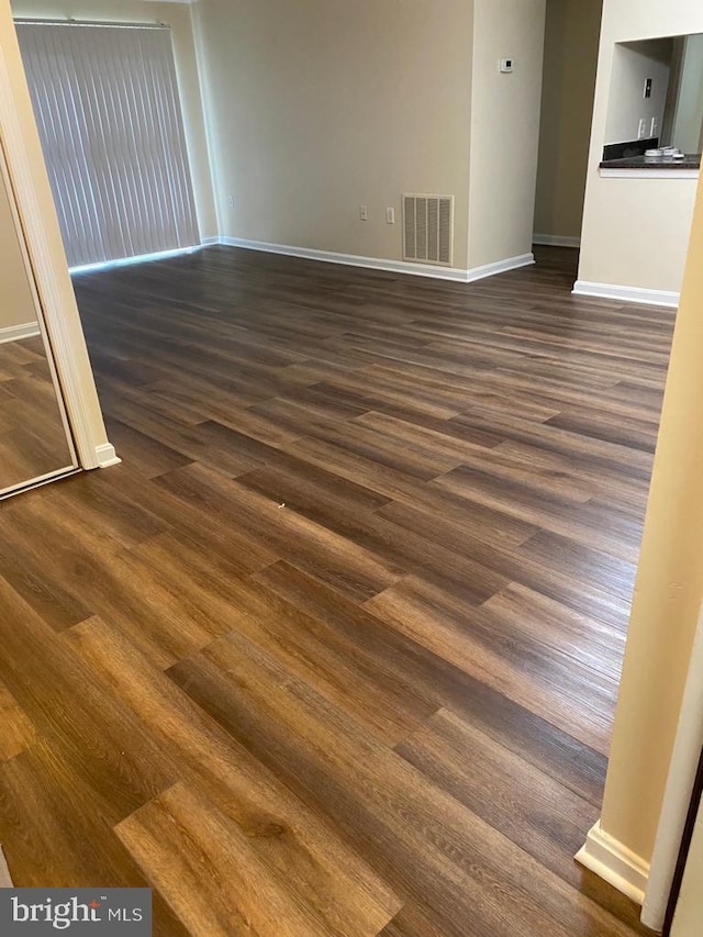 18318 Streamside Dr Unit 203, Gaithersburg, MD 20879 - spare room featuring baseboards and dark wood-type flooring