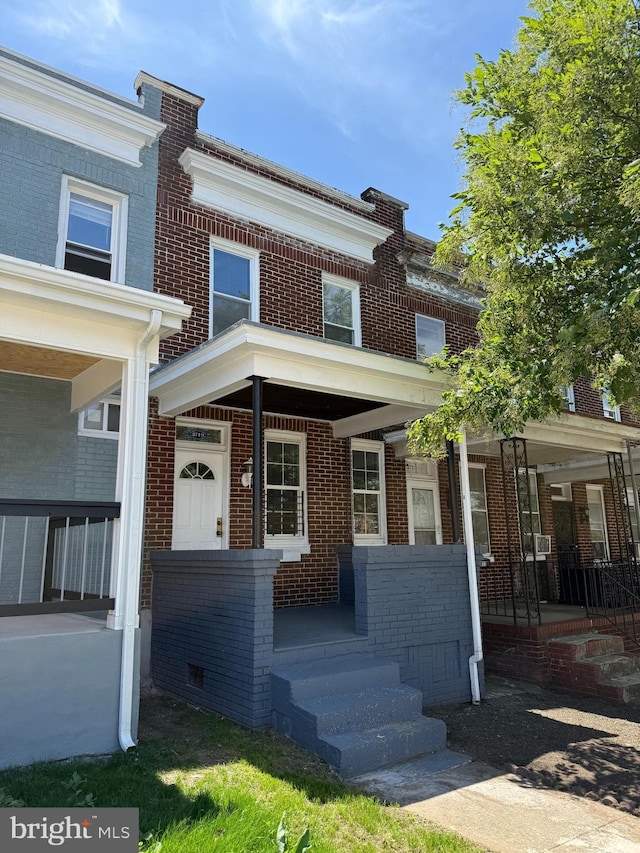 2719 Wilkens Ave, Baltimore, MD 21223 - view of property featuring a porch and brick siding