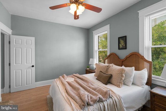 2719 Wilkens Ave, Baltimore, MD 21223 - bedroom with multiple windows, light wood-style flooring, and baseboards
