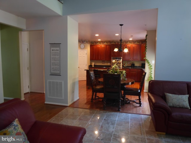 living room with a chandelier, wood finished floors, recessed lighting, and baseboards