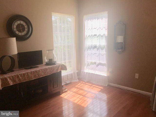 bedroom with wood finished floors and baseboards