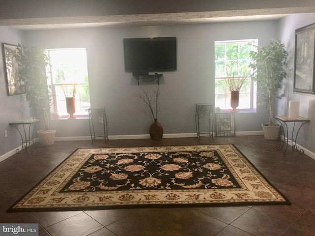 tiled living area featuring baseboards