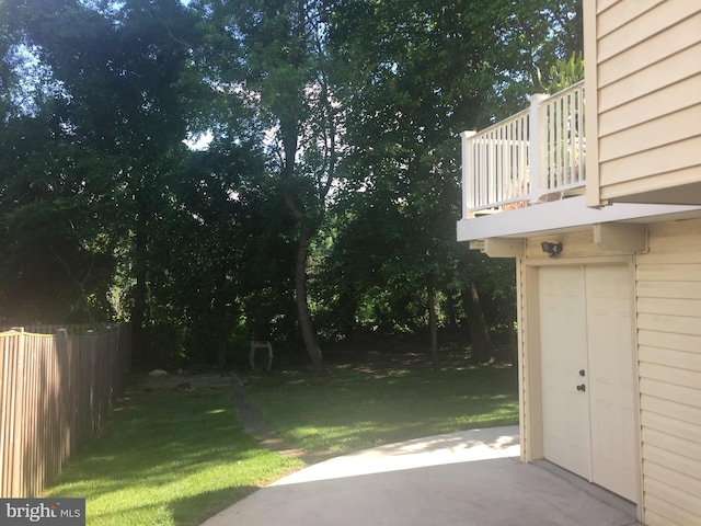 view of yard featuring a balcony and a patio area