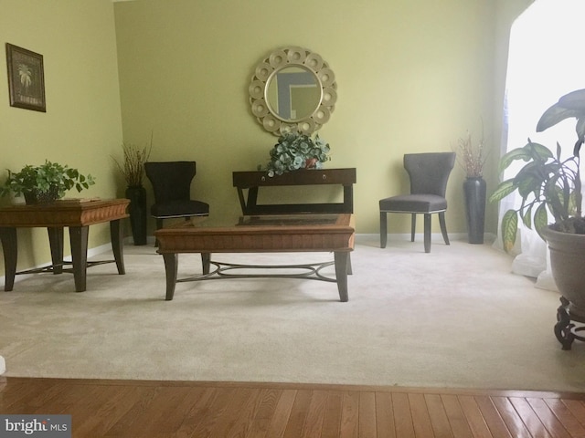 sitting room with wood finished floors and baseboards