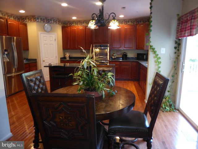 dining room with light wood-style flooring and recessed lighting