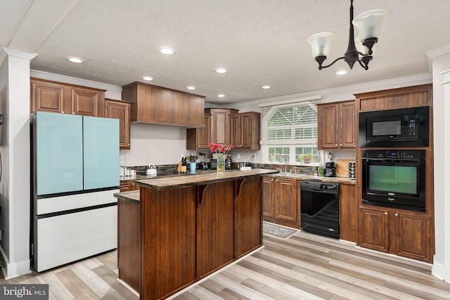 16155 Kerby Dr, Orange, VA 22960 - kitchen with black appliances, crown molding, a center island, dark countertops, and a chandelier