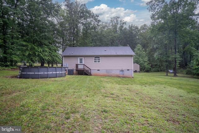 16155 Kerby Dr, Orange, VA 22960 - rear view of house featuring crawl space, central AC unit, a lawn, and an outdoor pool