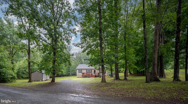 16155 Kerby Dr, Orange, VA 22960 - view of front facade with a wooden deck, a view of trees, and driveway