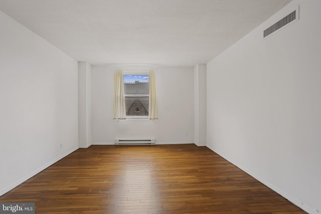 1101 Saint Paul St Unit 606, Baltimore, MD 21202 - spare room with hardwood / wood-style flooring, baseboard heating, and baseboards