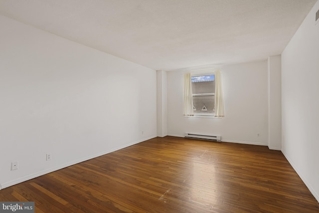 1101 Saint Paul St Unit 606, Baltimore, MD 21202 - empty room with a baseboard heating unit, wood-type flooring, and baseboards
