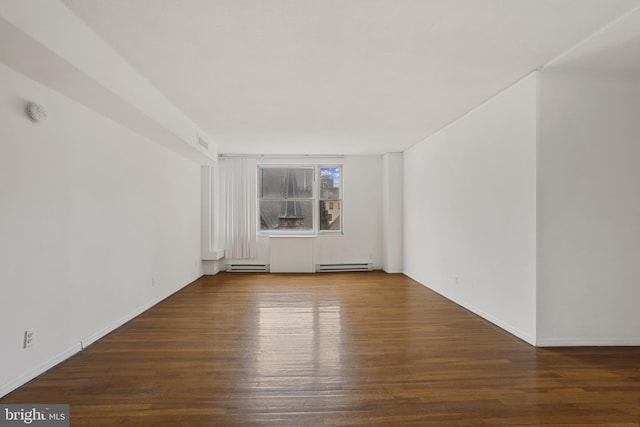 1101 Saint Paul St Unit 606, Baltimore, MD 21202 - unfurnished room featuring baseboard heating, wood finished floors, and baseboards