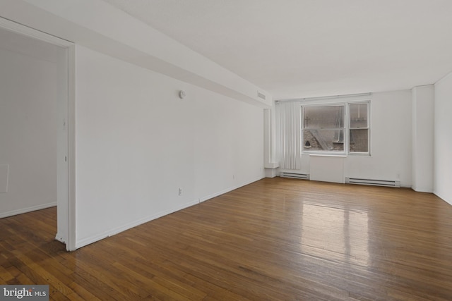 1101 Saint Paul St Unit 606, Baltimore, MD 21202 - spare room with wood finished floors, a baseboard radiator, and baseboards