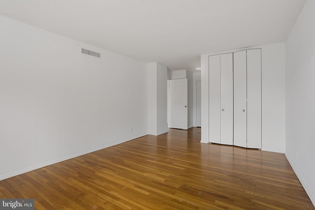 1101 Saint Paul St Unit 606, Baltimore, MD 21202 - unfurnished bedroom with wood-type flooring, a closet, and baseboards