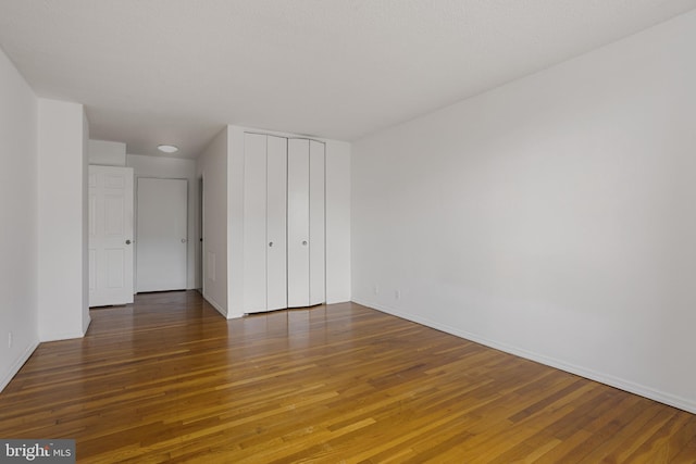 1101 Saint Paul St Unit 606, Baltimore, MD 21202 - unfurnished bedroom with hardwood / wood-style flooring, baseboards, and a closet