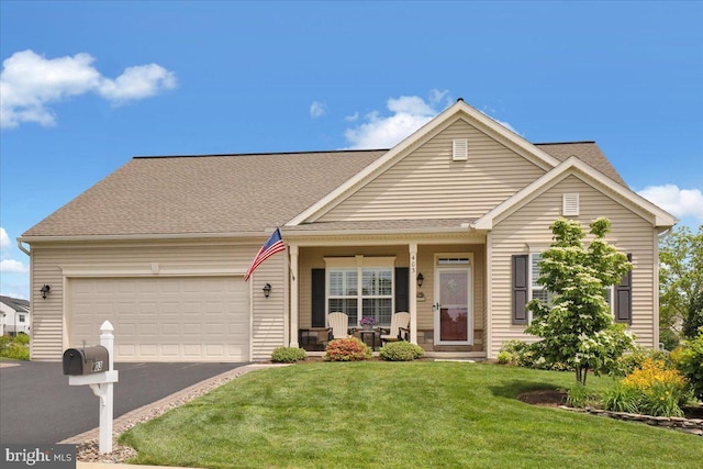 403 Orchid Cir, Lebanon, PA 17046 - view of front of property with a porch, asphalt driveway, an attached garage, a front lawn, and a shingled roof