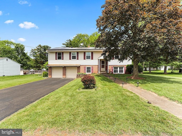 201 Hunter Ln, North Wales, PA 19454 - view of front facade featuring brick siding, driveway, a garage, and a front lawn