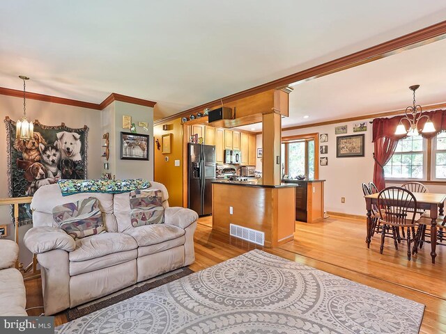 201 Hunter Ln, North Wales, PA 19454 - living area featuring a chandelier, ornamental molding, and light wood-type flooring