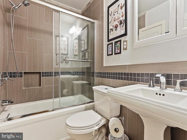 201 Hunter Ln, North Wales, PA 19454 - bathroom featuring tile walls, bath / shower combo with glass door, toilet, and a sink