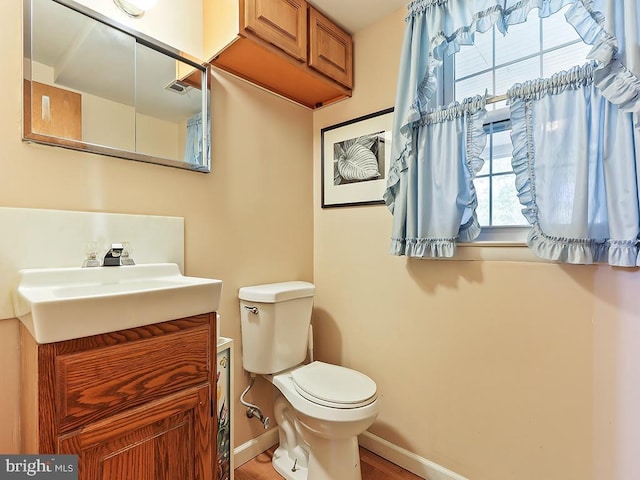 201 Hunter Ln, North Wales, PA 19454 - half bathroom featuring toilet, vanity, baseboards, and wood finished floors