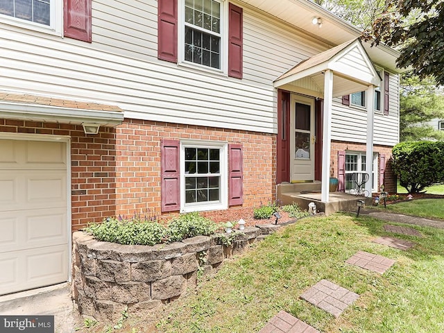 201 Hunter Ln, North Wales, PA 19454 - view of front of house featuring a garage, a front yard, and brick siding
