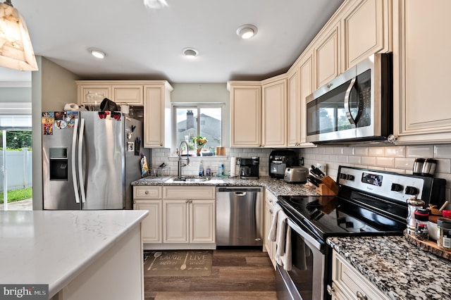 19 Buckwalter Rd, Audubon, PA 19403 - kitchen featuring appliances with stainless steel finishes, cream cabinets, a sink, and tasteful backsplash