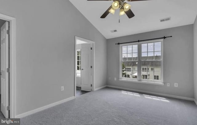 carpeted spare room with baseboards, a ceiling fan, and high vaulted ceiling