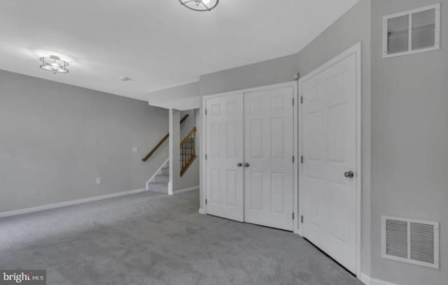 finished below grade area with carpet, baseboards, and stairs
