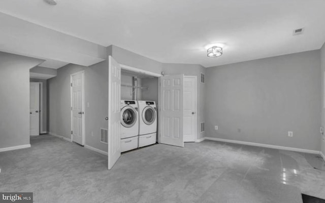 washroom featuring carpet floors, washing machine and clothes dryer, and baseboards