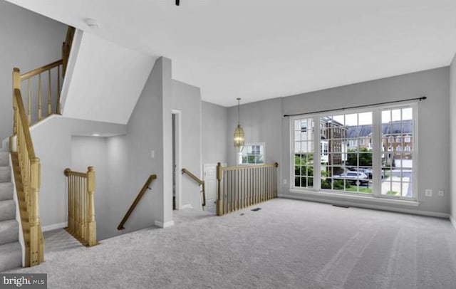 unfurnished room with carpet floors and baseboards
