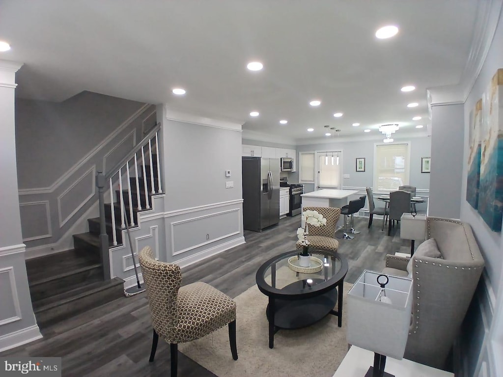 2800 Oswego Ave, Baltimore, MD 21215 - living room featuring crown molding, dark wood-style flooring, stairs, a decorative wall, and recessed lighting
