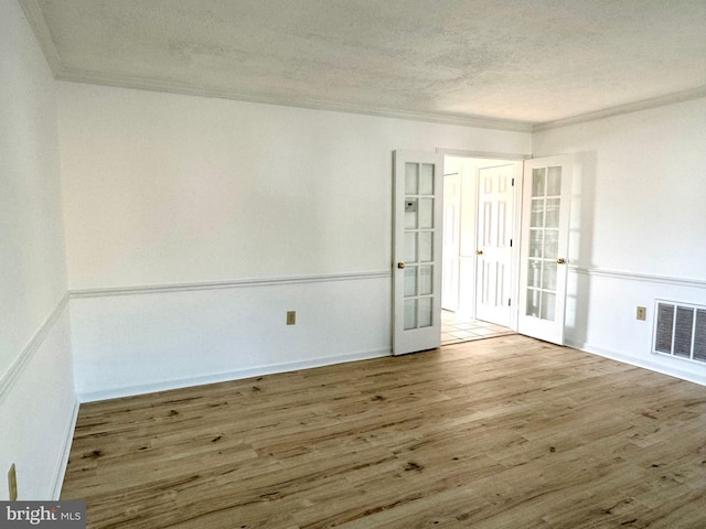 326 Banbury Ter, Winchester, VA 22601 - empty room with french doors, ornamental molding, wood finished floors, a textured ceiling, and baseboards