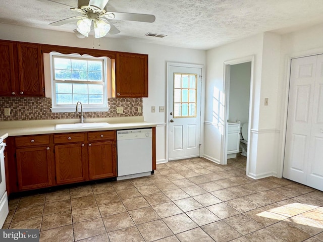 326 Banbury Ter, Winchester, VA 22601 - kitchen with white dishwasher, a sink, decorative backsplash, light countertops, and a textured ceiling