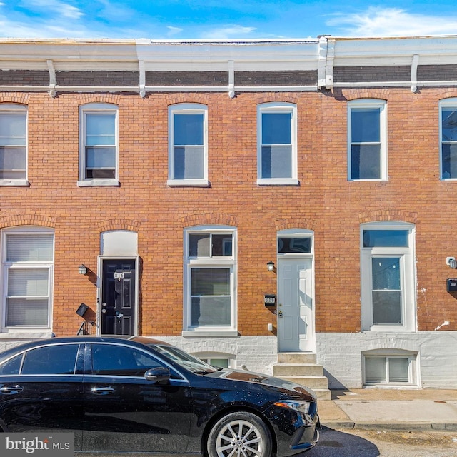 818 N Rose St, Baltimore, MD 21205 - townhome / multi-family property with entry steps and brick siding