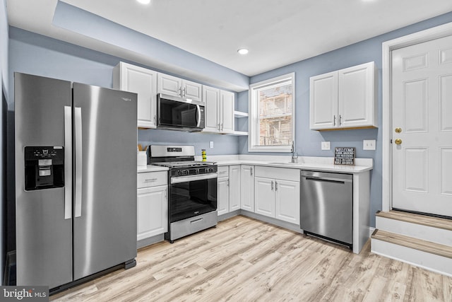 818 N Rose St, Baltimore, MD 21205 - kitchen with appliances with stainless steel finishes, light countertops, white cabinetry, light wood-type flooring, and recessed lighting