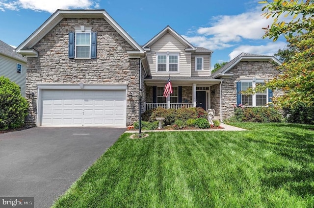18776 Pier Trail Dr, Triangle, VA 22172 - view of front of home with stone siding, a garage, asphalt driveway, a front yard, and a porch