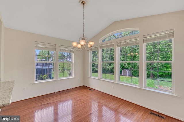 18776 Pier Trail Dr, Triangle, VA 22172 - spare room with a chandelier, hardwood / wood-style flooring, vaulted ceiling, and baseboards