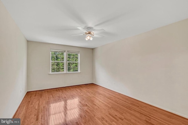 18776 Pier Trail Dr, Triangle, VA 22172 - unfurnished room with wood finished floors, ceiling fan, and baseboards