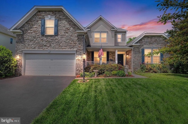 18776 Pier Trail Dr, Triangle, VA 22172 - view of front of house with stone siding, a garage, driveway, a front lawn, and covered porch