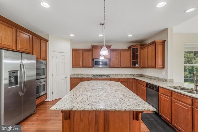 18776 Pier Trail Dr, Triangle, VA 22172 - kitchen featuring stainless steel appliances, brown cabinetry, a sink, a kitchen island, and recessed lighting