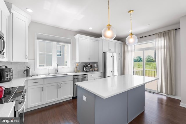 65 Tamarack Cir, Eagleville, PA 19403 - kitchen with appliances with stainless steel finishes, a sink, decorative backsplash, white cabinetry, and a kitchen island