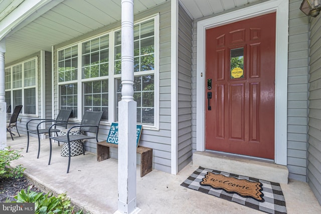 view of exterior entry with a porch