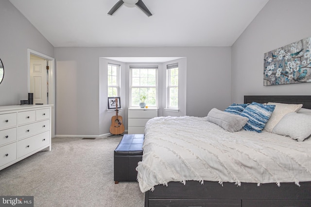 bedroom with vaulted ceiling, carpet, baseboards, and a ceiling fan