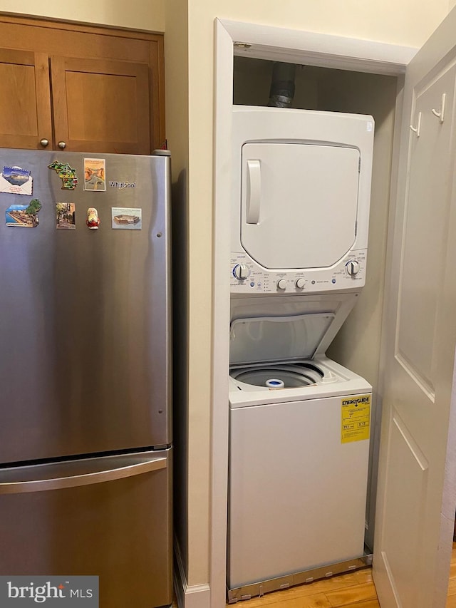 1858 California St NW Unit 33, Washington, DC 20009 - laundry area featuring stacked washing machine and dryer and light wood-style flooring