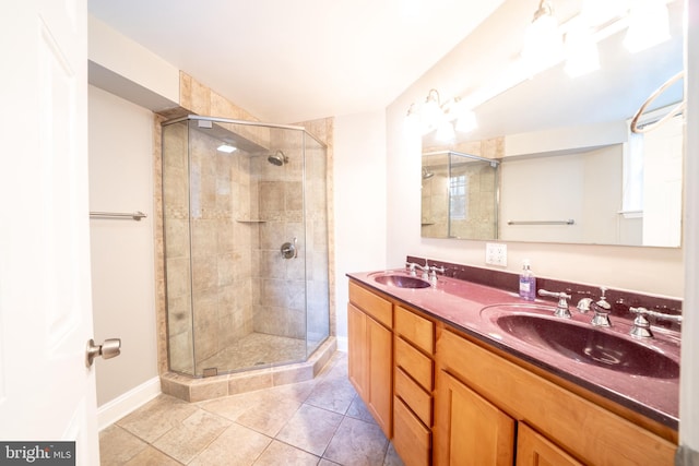 2510 Ontario Rd NW Unit 1, Washington, DC 20009 - bathroom with a shower stall, tile patterned flooring, baseboards, and double vanity