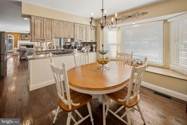 503 Dugout Dr, Lanoka Harbor, NJ 08734 - dining space with a chandelier, baseboards, dark wood-type flooring, a tiled fireplace, and recessed lighting
