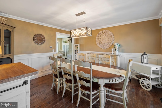 503 Dugout Dr, Lanoka Harbor, NJ 08734 - dining space with a wainscoted wall, crown molding, wood-type flooring, a chandelier, and a decorative wall