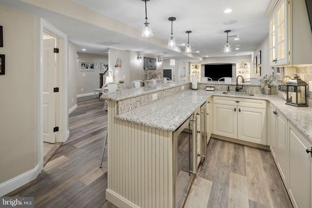 503 Dugout Dr, Lanoka Harbor, NJ 08734 - kitchen featuring a sink, open floor plan, wood finished floors, recessed lighting, and a kitchen breakfast bar